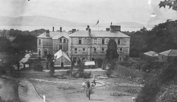 Redburn House: back of house, conservatory, fountain, view across Belfast Lough to County Antrim